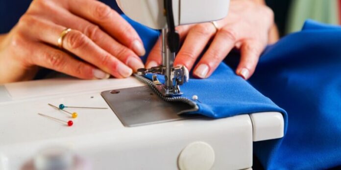 Sewing workshop. Sewing zipper on sewing machine.