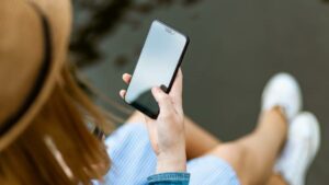 person holding smartphone white sitting 1310532